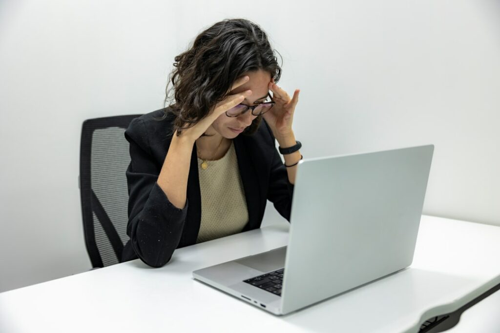 Stressed person at a laptop after a frustrating online experience