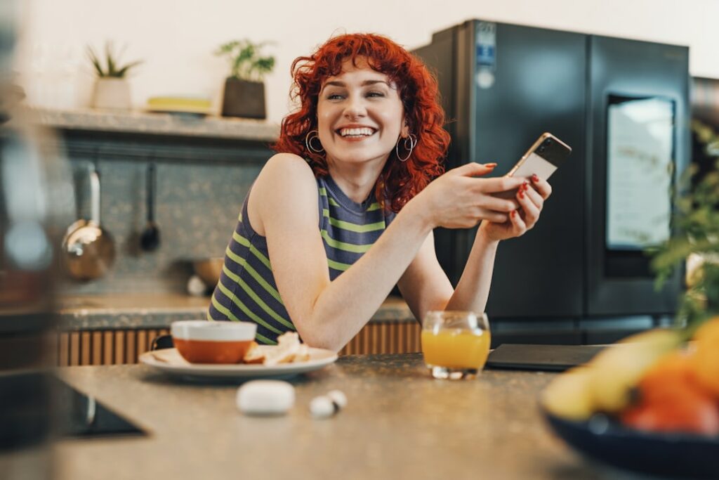Woman smiling while reading business reviews on her phone