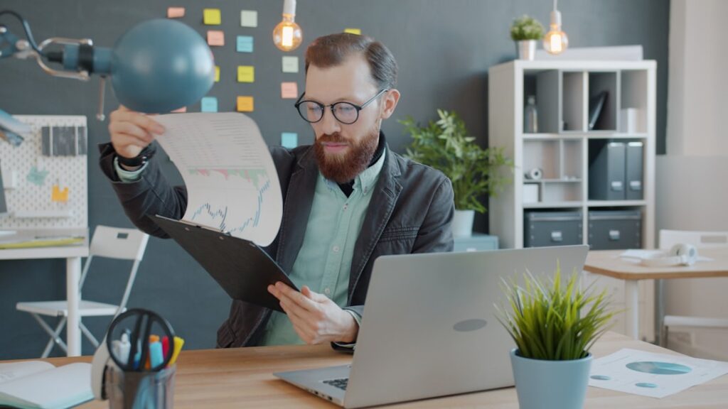 Business owner reviewing competitor websites on a laptop screen