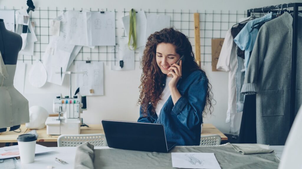 Small business owner on a phone call at their shop counter