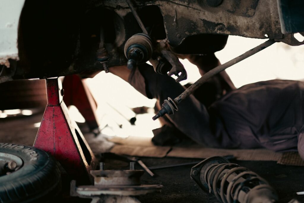 Mechanics working together in a busy auto repair shop