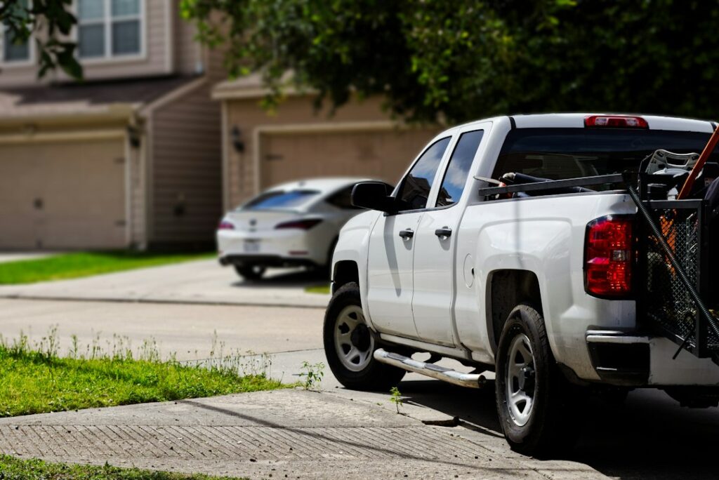 White service truck parked on a residential street for a local job
