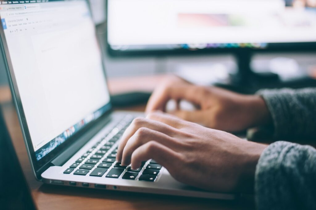 Person typing on a laptop crafting a service page for their business