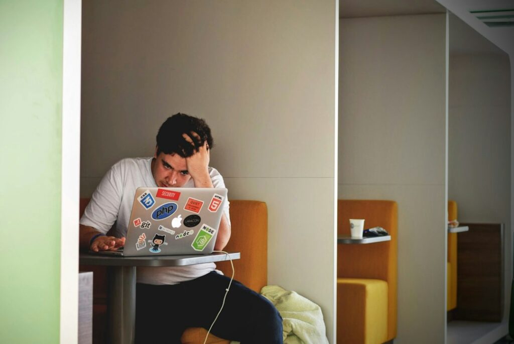 Person staring at confusing website navigation on their laptop